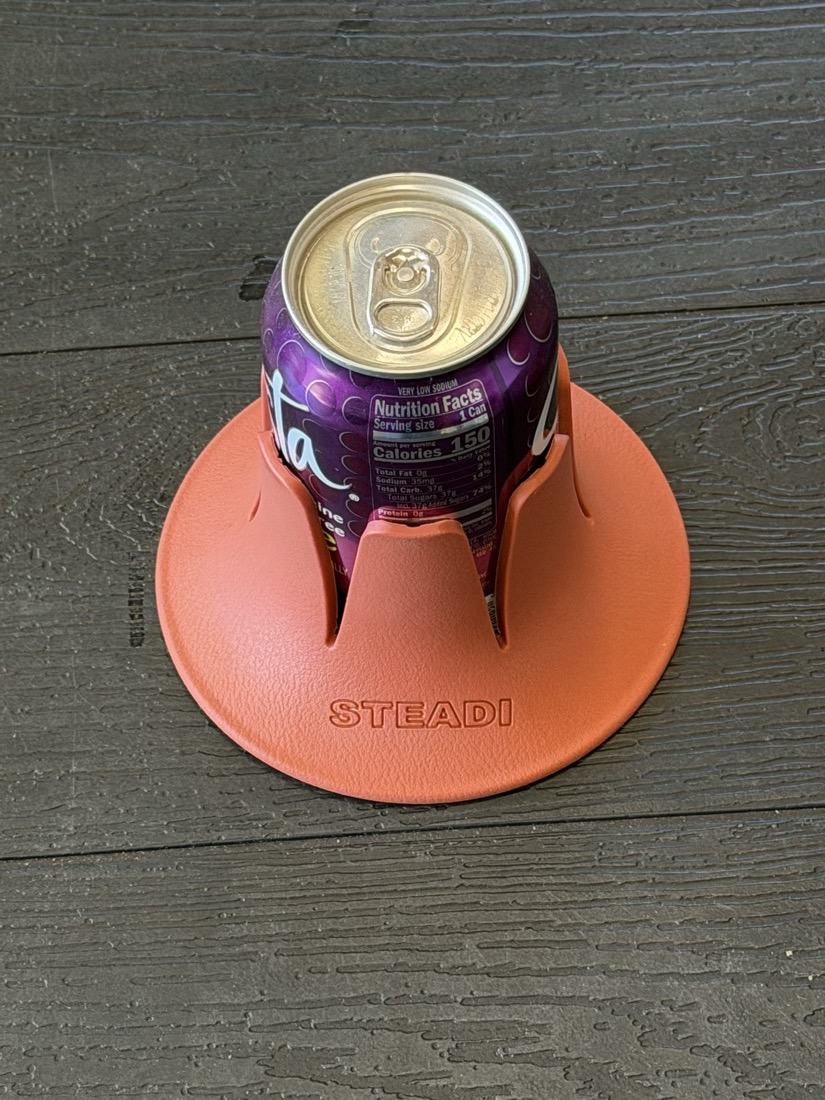 A can seated in a terracotta Steadi photographed from above, showing the full width of the flared base around it.
